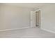 A bedroom with neutral carpeting and paint, with a single door and double door to hall or closet at 7215 Barrett Dr, Brownsburg, IN 46112