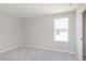 A bright bedroom showcasing a large window and soft carpeting, perfect for relaxation and comfort at 7215 Barrett Dr, Brownsburg, IN 46112