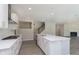 Well-lit kitchen with a large island, stainless steel appliances, and open floor plan at 7215 Barrett Dr, Brownsburg, IN 46112