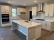 Bright, modern kitchen with white cabinets, stainless steel appliances, and a large center island at 7215 Barrett Dr, Brownsburg, IN 46112