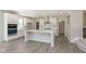 Open kitchen features white cabinets, stainless appliances, and center island at 7215 Barrett Dr, Brownsburg, IN 46112