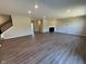 Spacious living room with hardwood floors, a fireplace, and stairs leading to the second floor at 7215 Barrett Dr, Brownsburg, IN 46112