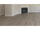 Open living space with fireplace and gray wood floors at 7215 Barrett Dr, Brownsburg, IN 46112