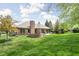 Spacious backyard featuring a brick firepit and well-manicured lawn at 7340 Stones River Dr, Indianapolis, IN 46259
