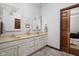 Stylish bathroom featuring double vanity, decorative mirrors, and modern light fixtures at 7340 Stones River Dr, Indianapolis, IN 46259