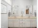 Well-lit bathroom with double sink vanity, framed mirrors, and updated fixtures, offering a clean and modern space at 7340 Stones River Dr, Indianapolis, IN 46259