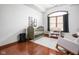 This bright Bedroom features hardwood floors, a large arched window, and neutral accents creating a calming space at 7340 Stones River Dr, Indianapolis, IN 46259