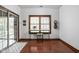 Bright entryway with sliding glass doors, stylish rug, and a workstation illuminated by a large window at 7340 Stones River Dr, Indianapolis, IN 46259