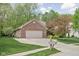 A well-maintained brick home with an attached two-car garage and lovely landscaping at 7340 Stones River Dr, Indianapolis, IN 46259