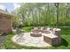 Backyard firepit with custom brick seating and lush landscaping at 7340 Stones River Dr, Indianapolis, IN 46259