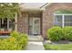 Inviting front porch with charming decor, a cozy bench, and a beautifully landscaped entrance at 7340 Stones River Dr, Indianapolis, IN 46259