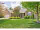 Charming brick home with a well-manicured lawn and mature trees in a desirable neighborhood at 7340 Stones River Dr, Indianapolis, IN 46259