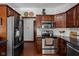 Modern kitchen with stainless steel appliances, granite countertops, and ample cabinet space with hardwood floors at 7340 Stones River Dr, Indianapolis, IN 46259