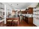 Spacious kitchen with dark wood cabinets, a breakfast bar, and modern pendant lighting at 7340 Stones River Dr, Indianapolis, IN 46259