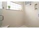 Bright shower with tile walls, a built-in seat, and a window for natural light enhancing a clean aesthetic at 7340 Stones River Dr, Indianapolis, IN 46259