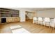 Stylish bar area with modern cabinetry, wooden shelves and seating at 8082 Abington Way, Zionsville, IN 46077