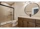 Modern bathroom with a glass-enclosed shower, round mirror, and stylish vanity at 8082 Abington Way, Zionsville, IN 46077