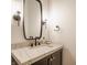 Elegant powder room featuring marble countertops, a vessel sink, modern lighting fixtures, and gold hardware at 8082 Abington Way, Zionsville, IN 46077