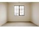 A minimalist bedroom with large window and carpet, providing natural light and comfortable space at 8082 Abington Way, Zionsville, IN 46077
