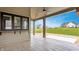 View of the covered patio featuring stamped concrete floors, a ceiling fan, and an outdoor kitchen window at 8082 Abington Way, Zionsville, IN 46077