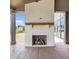 View of the covered patio featuring a brick fireplace with a wooden mantel and stamped concrete floors at 8082 Abington Way, Zionsville, IN 46077