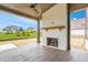View of the covered patio featuring a ceiling fan and a brick fireplace with a wooden mantel at 8082 Abington Way, Zionsville, IN 46077