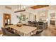 Dining room area with a large table, modern light fixture, and an open view to the kitchen at 8082 Abington Way, Zionsville, IN 46077