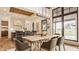Bright dining room area with hardwood floors, large windows, and an open view to the kitchen at 8082 Abington Way, Zionsville, IN 46077