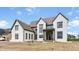 Exterior of a two-story home featuring a front porch with a wooden beam entryway and a gray shingle roof at 8082 Abington Way, Zionsville, IN 46077
