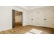 Hallway featuring wood floors, a sliding door to another room and white double doors for closet space at 8082 Abington Way, Zionsville, IN 46077