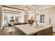 Modern kitchen featuring an island with marble countertops, stylish pendant lighting, and hardwood floors at 8082 Abington Way, Zionsville, IN 46077