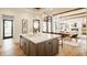 Open concept kitchen with large island, stainless steel appliances, and hardwood flooring at 8082 Abington Way, Zionsville, IN 46077