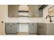 Stylish kitchenette with sleek gray cabinets, a quartz countertop, and modern fixtures at 8082 Abington Way, Zionsville, IN 46077