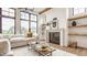 Cozy living room featuring a modern fireplace, floating shelves, and large windows for natural light at 8082 Abington Way, Zionsville, IN 46077