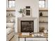Cozy living room featuring a modern fireplace, floating shelves, and large windows for natural light at 8082 Abington Way, Zionsville, IN 46077