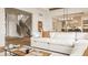 Bright, open-concept living room featuring a white sofa, wood floors, and staircase views at 8082 Abington Way, Zionsville, IN 46077
