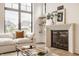 Cozy living room featuring a modern fireplace, floating shelves, and large windows for natural light at 8082 Abington Way, Zionsville, IN 46077