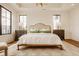 This serene main bedroom boasts large windows, light walls, and stylish furniture on top of sleek hardwood floors at 8082 Abington Way, Zionsville, IN 46077