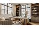 Bright home office with built-in bookcases, a large picture window, and a patterned rug at 8082 Abington Way, Zionsville, IN 46077