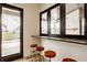Outdoor patio bar with countertop window and stools, and a pass-through to the kitchen area at 8082 Abington Way, Zionsville, IN 46077