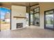 Covered patio with a cozy fireplace and an outdoor fan, perfect for entertaining at 8082 Abington Way, Zionsville, IN 46077