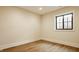 Bright room with wood floors, a window, white trim and neutral paint at 8092 Abington Way, Zionsville, IN 46077