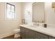 Charming bathroom features a gray vanity with marble countertop, gold accents, and natural light at 8092 Abington Way, Zionsville, IN 46077