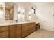 Double vanity bathroom features wooden cabinets, matching mirrors, and bench seating at 8092 Abington Way, Zionsville, IN 46077