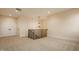 Spacious bonus room with plush carpet, stylish pendant lighting, and staircase access at 8092 Abington Way, Zionsville, IN 46077