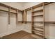 Walk-in closet features custom wood shelving, providing ample storage and organization space at 8092 Abington Way, Zionsville, IN 46077