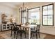 This dining room offers natural light and a modern chandelier at 8092 Abington Way, Zionsville, IN 46077