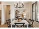 This dining room has a rustic chandelier and modern decor at 8092 Abington Way, Zionsville, IN 46077