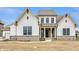 Stunning two-story home with white siding, striking black windows and attractive gray brick foundation at 8092 Abington Way, Zionsville, IN 46077