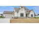 Beautiful two-story home featuring white siding, a brick foundation, and a three-car garage at 8092 Abington Way, Zionsville, IN 46077